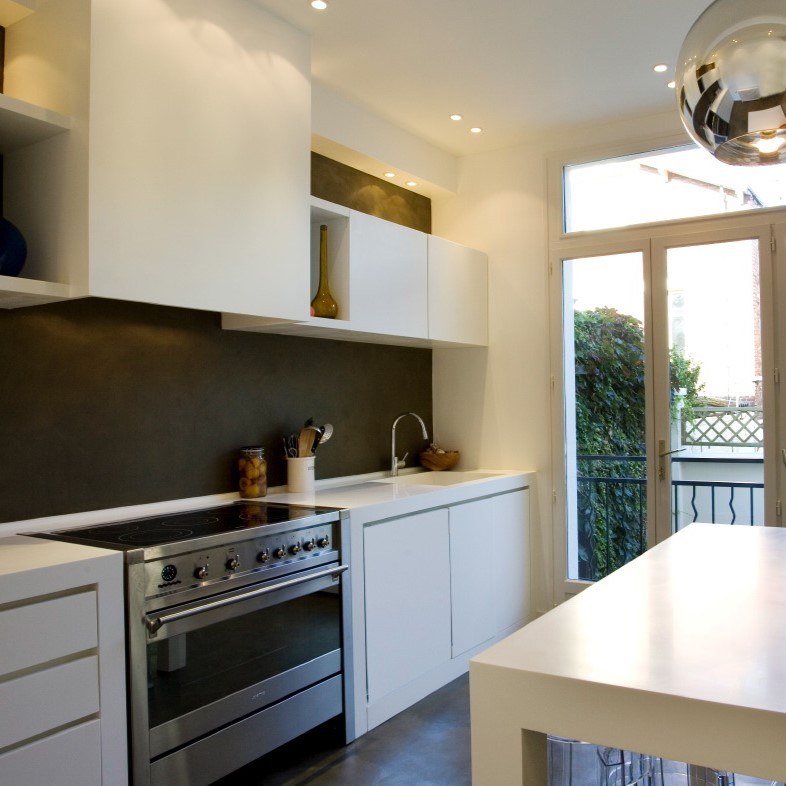 Cuisine ouverte sur le jardin de la maison transformée et agrandie en proche banlieue